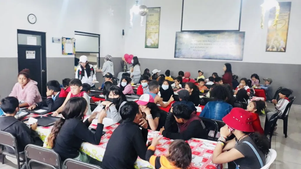 Comedor comunitario lleno de niños durante una jornada de alimentación